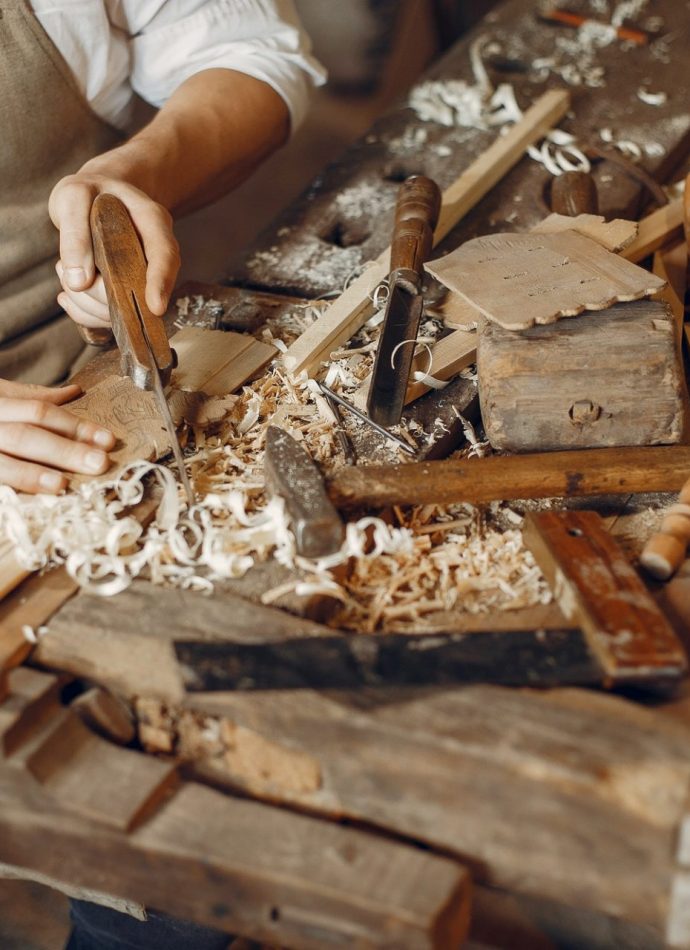 handsome-carpenter-working-with-a-wood-e1623128999508